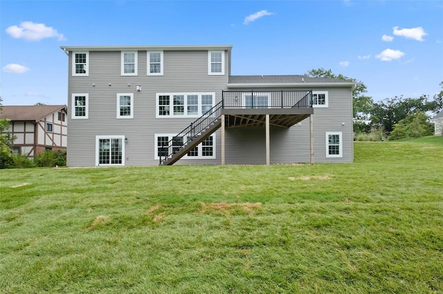 back of property featuring a wooden deck and a yard