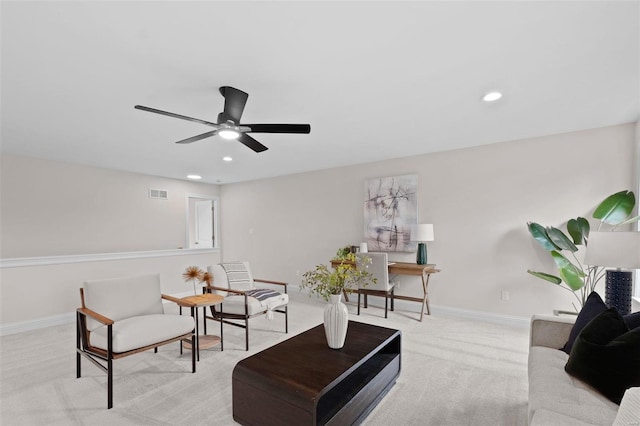 carpeted living room featuring ceiling fan