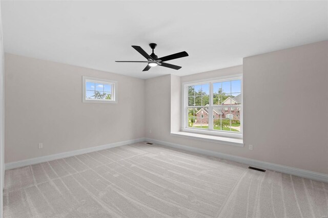 carpeted empty room featuring ceiling fan