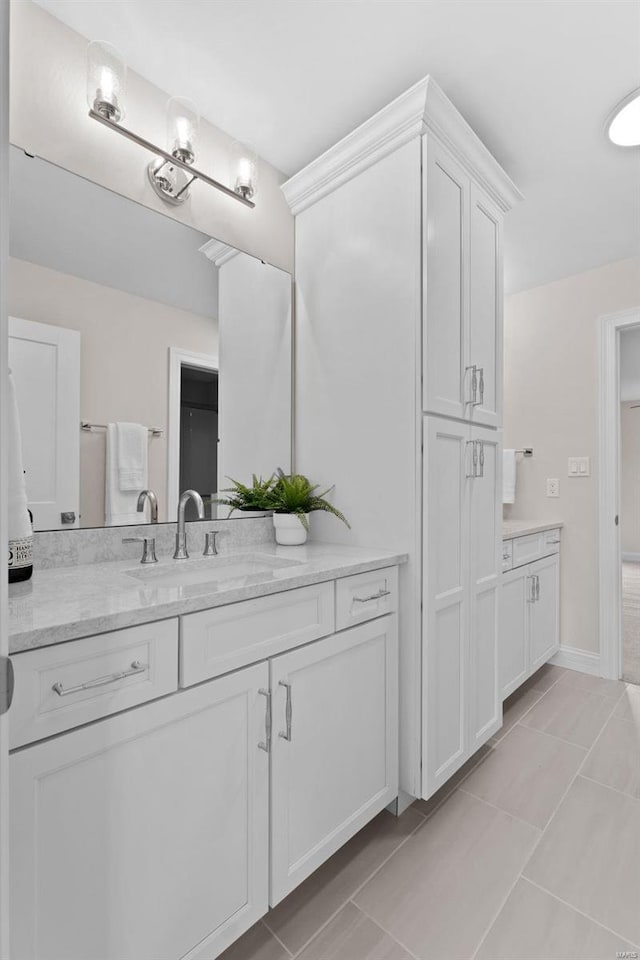 bathroom with tile patterned flooring and vanity