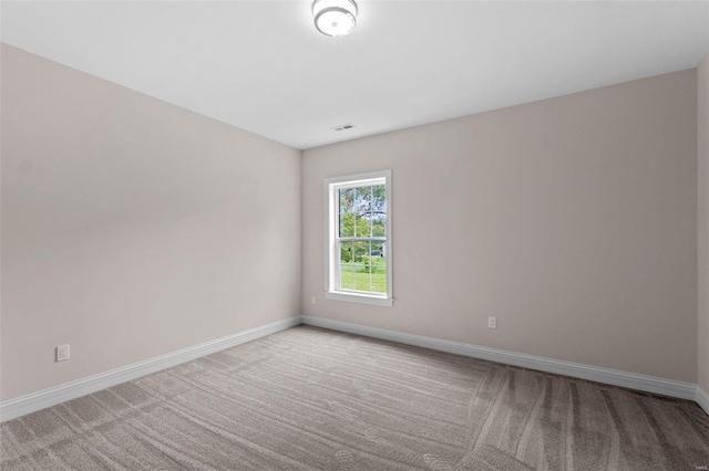 unfurnished room featuring light carpet