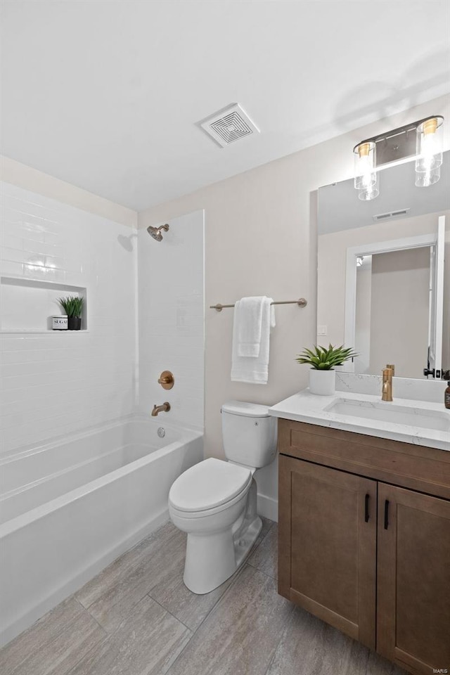 full bathroom with vanity, toilet, washtub / shower combination, and hardwood / wood-style floors