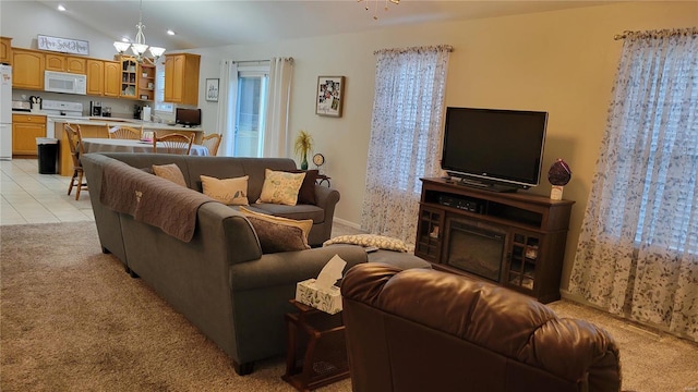 living room with vaulted ceiling, a notable chandelier, and light carpet