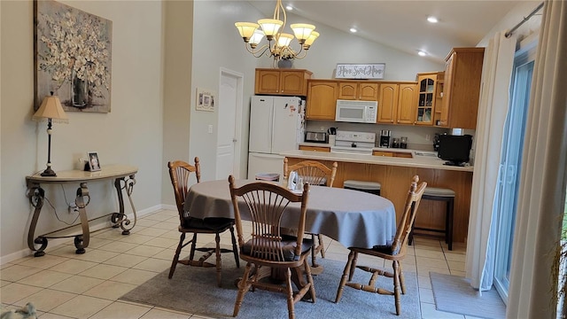 tiled dining space featuring high vaulted ceiling and a chandelier