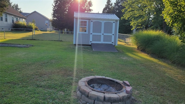 exterior space featuring a lawn and an outdoor fire pit