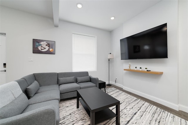 living room featuring beamed ceiling and hardwood / wood-style floors