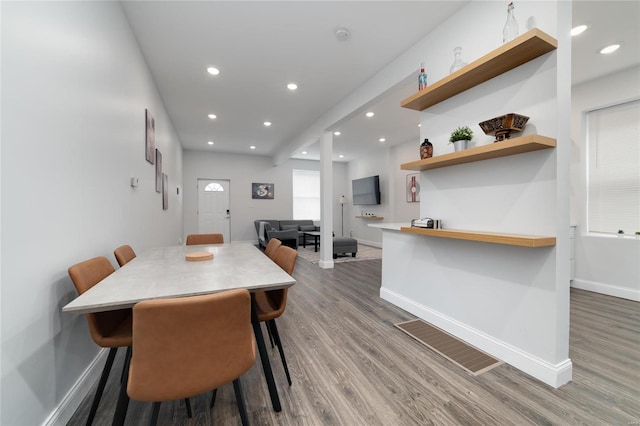 dining area featuring dark wood-type flooring