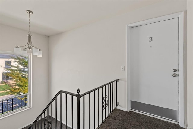 interior space featuring a chandelier and carpet