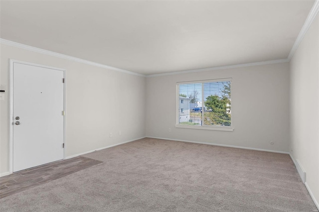 spare room with crown molding and light carpet