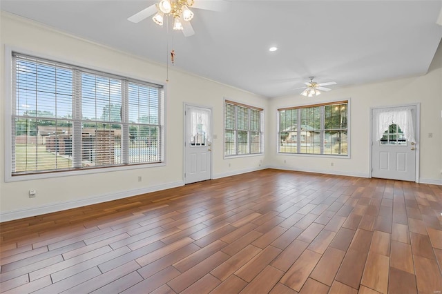 unfurnished living room with hardwood / wood-style floors, ceiling fan, and crown molding