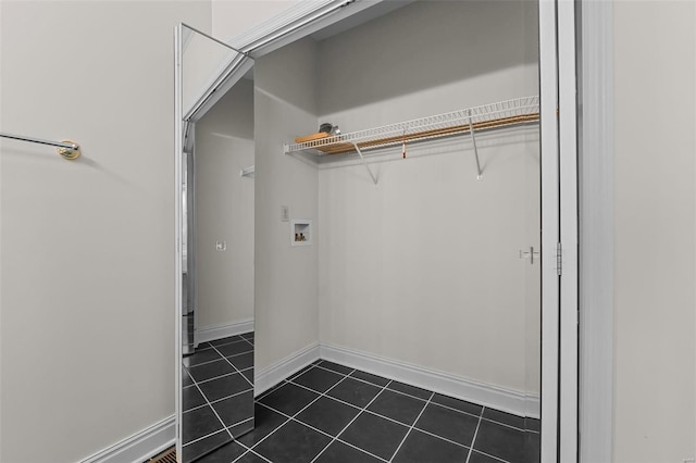 laundry room with washer hookup and dark tile patterned floors