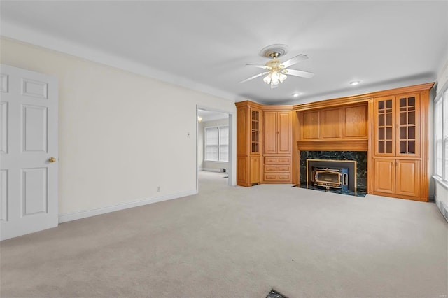 unfurnished living room with ceiling fan and light colored carpet