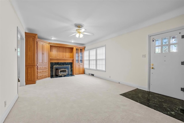 carpeted living room with ceiling fan and crown molding