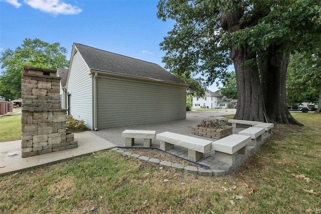 exterior space featuring an outdoor fire pit and a patio area