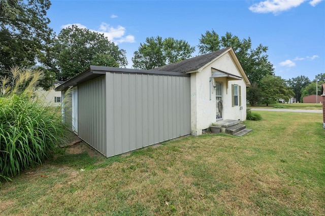 view of side of home with a lawn