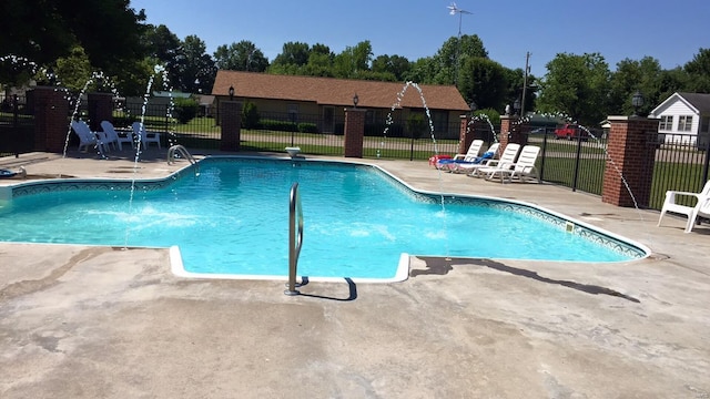 pool with fence and a patio area