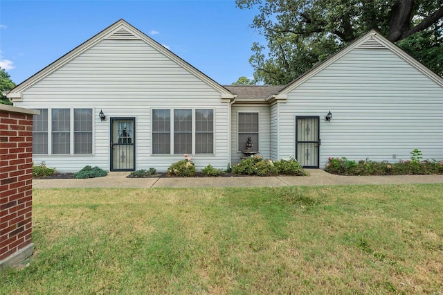 view of front of property with a front yard and roof with shingles