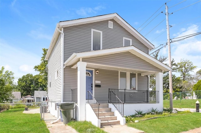 view of front of property with a front lawn and covered porch