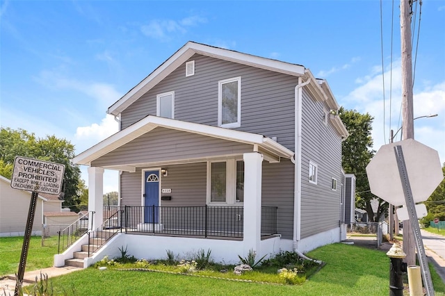 view of front of home with a front lawn and covered porch