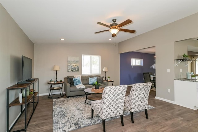 living room with dark wood-type flooring, lofted ceiling, and ceiling fan