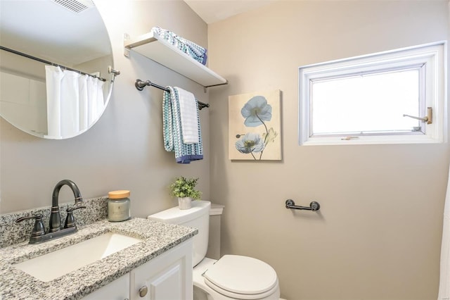 bathroom featuring vanity, toilet, and a shower with shower curtain