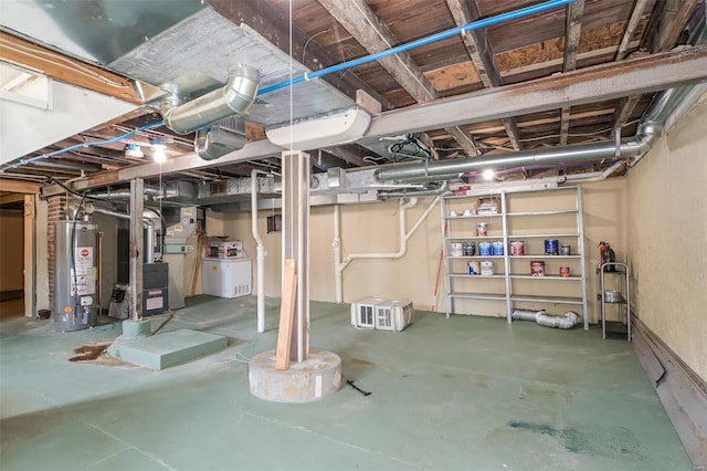 basement featuring gas water heater and washer / dryer