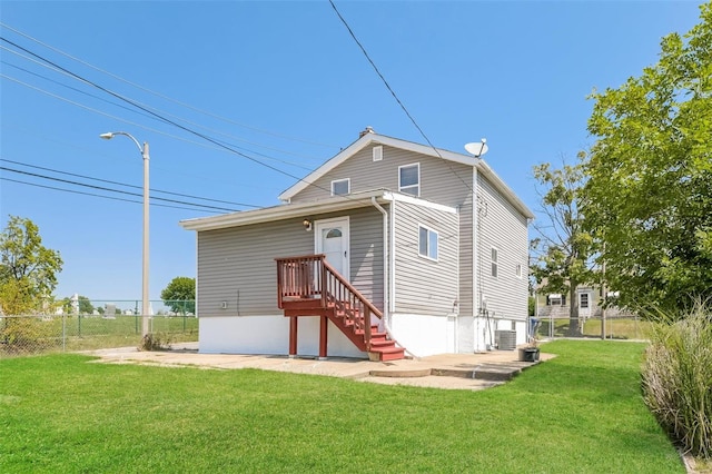 back of house with a lawn