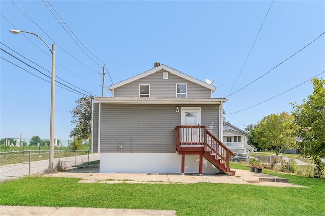 rear view of house with a lawn