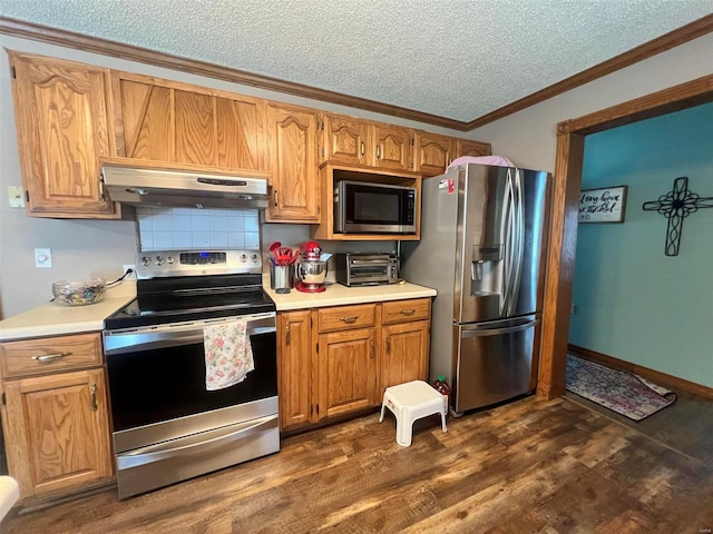 kitchen featuring ornamental molding, dark wood-type flooring, a textured ceiling, and appliances with stainless steel finishes