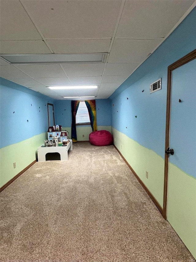 game room featuring a paneled ceiling and carpet