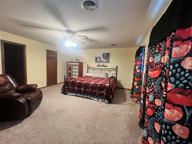 bedroom featuring a textured ceiling, carpet flooring, and ceiling fan