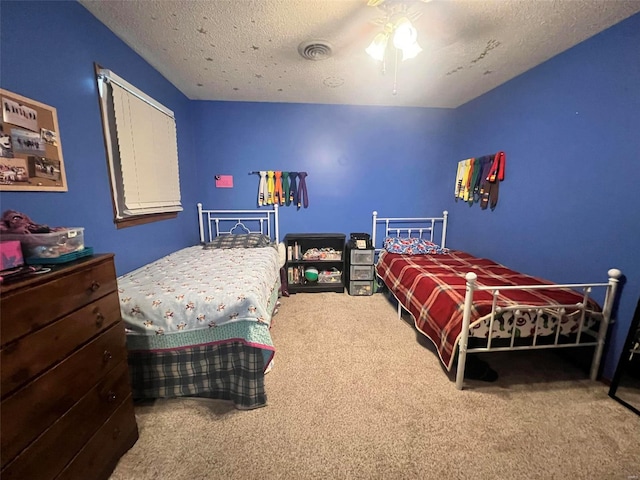 bedroom featuring a textured ceiling, ceiling fan, and carpet flooring