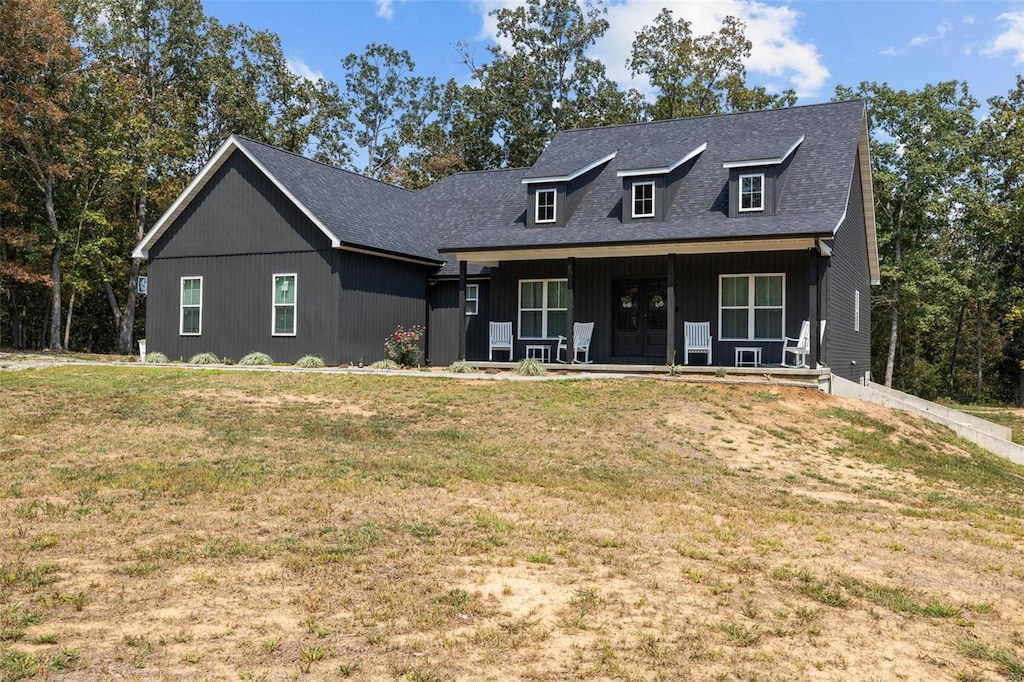 view of front of house featuring a front yard and a porch