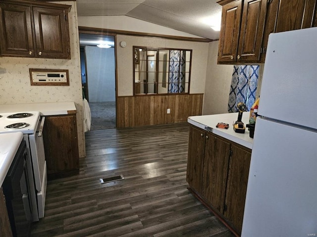 kitchen featuring vaulted ceiling, dark hardwood / wood-style floors, white appliances, and dark brown cabinets