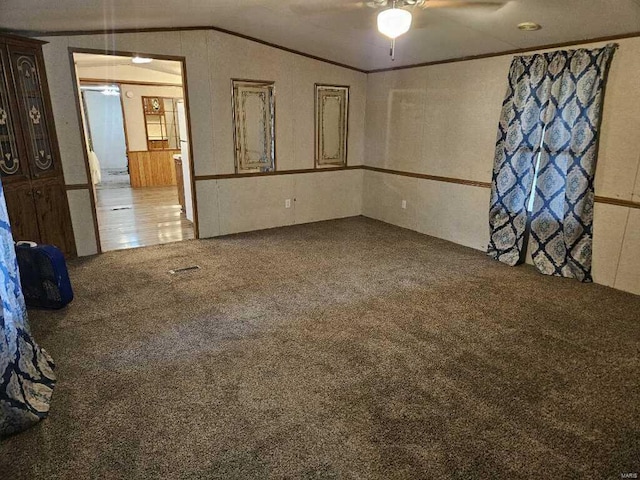 empty room with ceiling fan, carpet, and vaulted ceiling