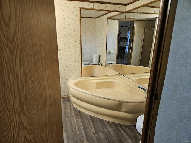 bathroom featuring hardwood / wood-style floors, independent shower and bath, and toilet