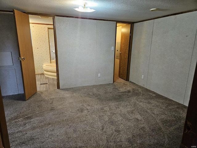 unfurnished bedroom featuring carpet flooring and a textured ceiling