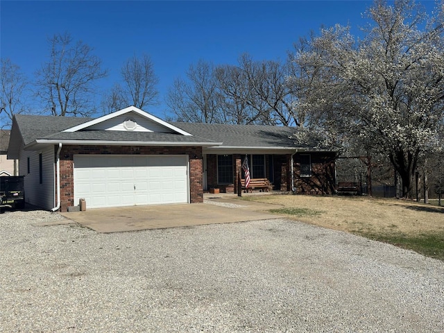 ranch-style home with a garage and a porch