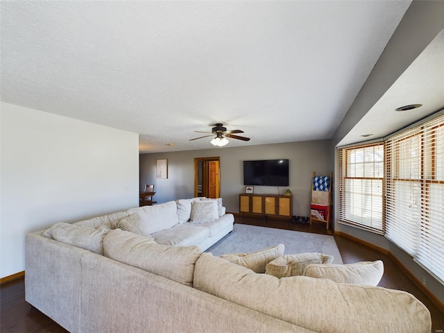 living room featuring a textured ceiling, ceiling fan, and dark hardwood / wood-style flooring