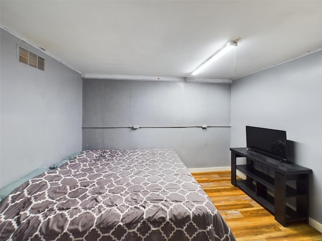 bedroom with hardwood / wood-style flooring