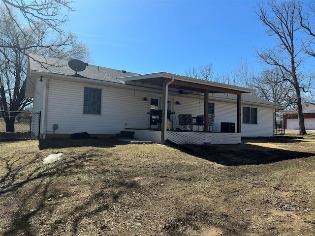 rear view of house with a yard and a deck