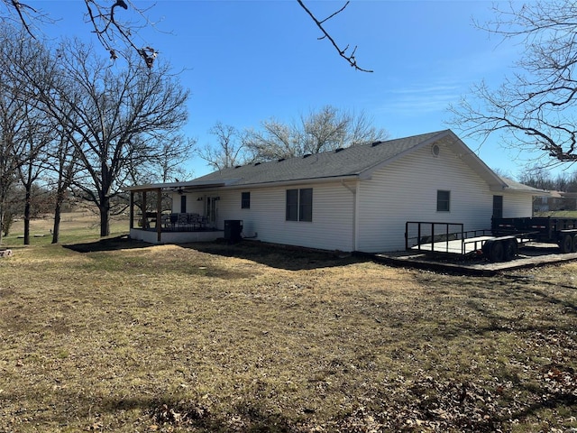 rear view of house featuring a yard and a patio