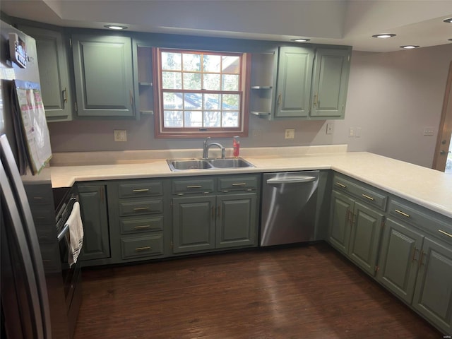 kitchen with sink, appliances with stainless steel finishes, and dark hardwood / wood-style flooring