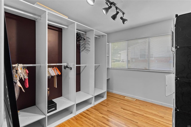 spacious closet featuring hardwood / wood-style flooring