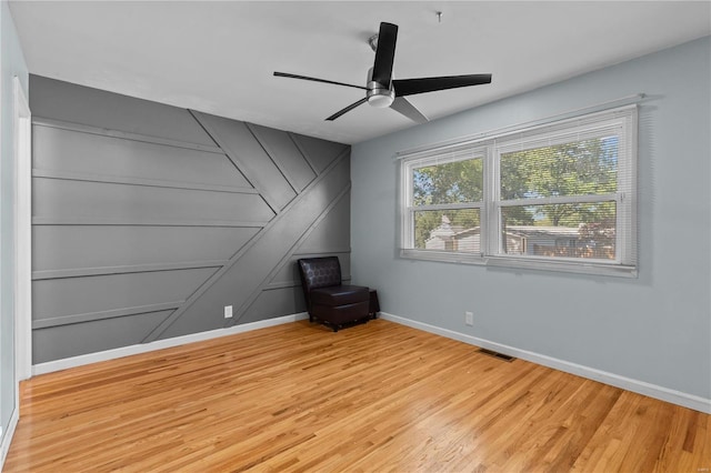 spare room with ceiling fan and light wood-type flooring