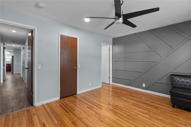 unfurnished bedroom featuring ceiling fan and hardwood / wood-style flooring