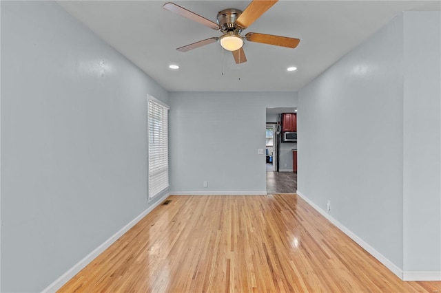 empty room with light hardwood / wood-style flooring and ceiling fan