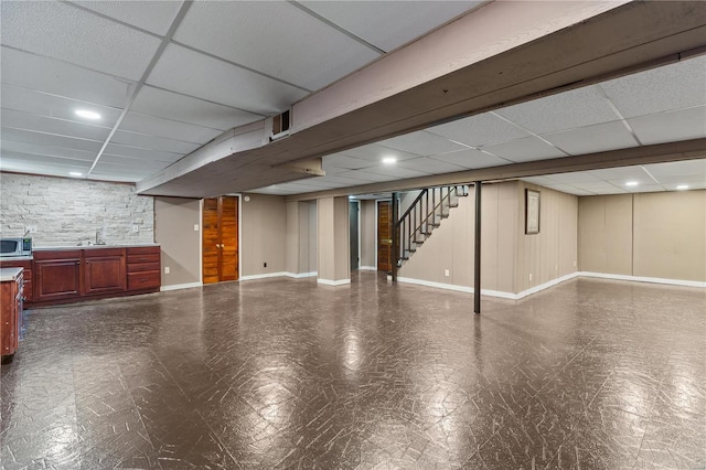 basement with sink and a drop ceiling