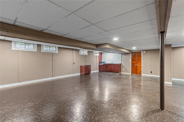 basement with a paneled ceiling