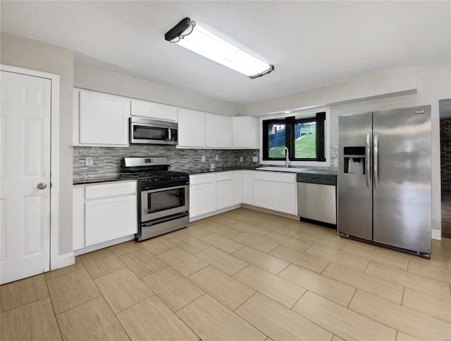 kitchen featuring light tile patterned floors, stainless steel appliances, tasteful backsplash, and sink